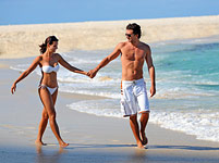 Enjoy endless powder-white beaches. couple walking on white beach